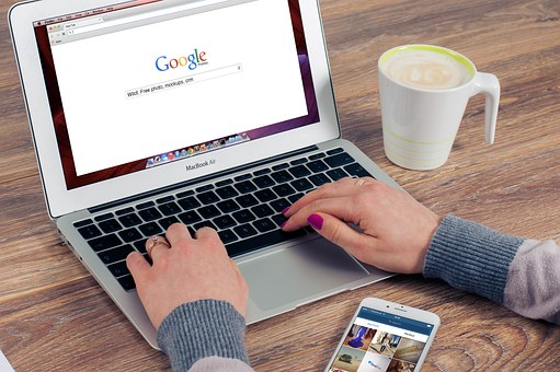 Person using laptop and coffee